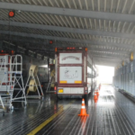 Parking area with vans to cool pig transporter down